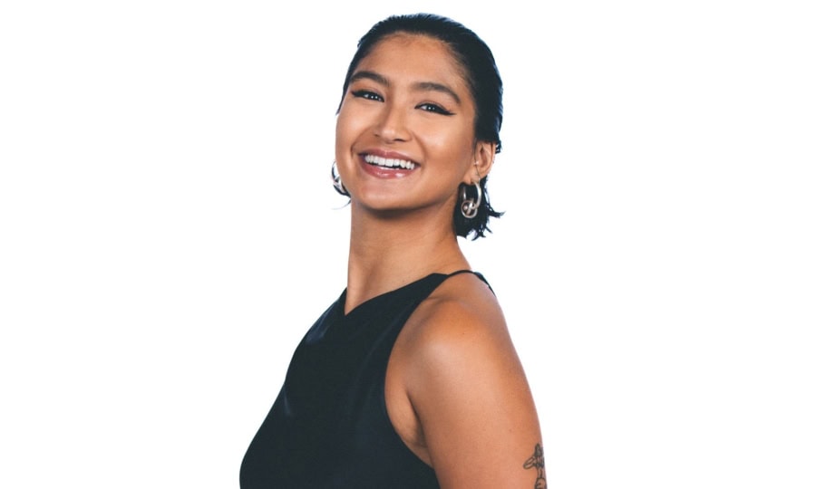 Photo of woman with short dark hair and black dress smiling for camera