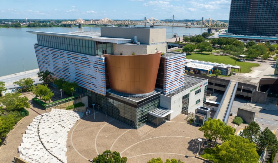 Photo of the exterior of the Muhammad Ali Center captured from a drone, showcasing the Ohio River behind the building