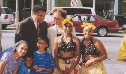 Muhammad and Lonnie Ali with a group of children dressed up in traditional celebration garb